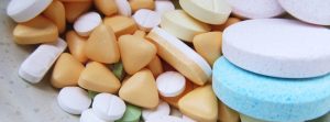 Variety of different pills on counter.