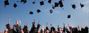 Graduating class throwing their caps in the air.