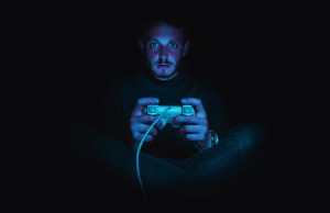 Man gaming in the dark.
