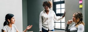 Three women in a business meeting.