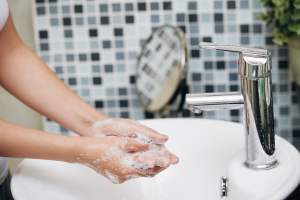 Woman washing her hands in a sink