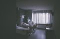 Dim hospital room with two beds.