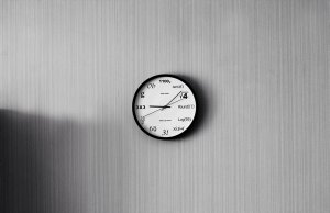 gray wall with white and black clock with math equations.