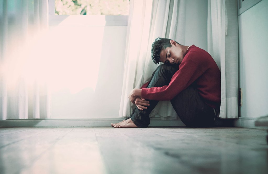 man in red shirt on floor
