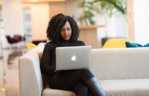 woman using laptop on couch