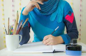 woman drawing in notebook