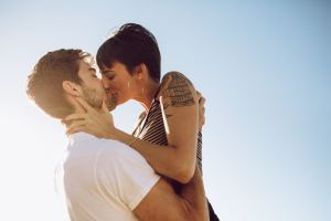 Couple kissing in the sun.