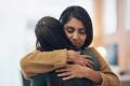 Two women hugging.