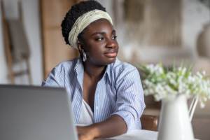 Woman at a computer looking away