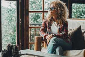 Woman with legs crossed sitting on a couch