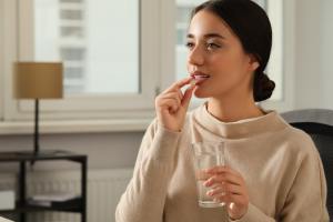 Woman taking medication.