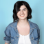 Anna Borges headshot on a bright blue background