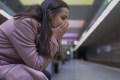 Woman suffering anxiety attack at subway station, feeling helpless